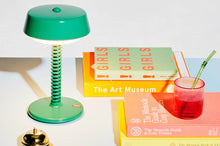 Load image into Gallery viewer, Jungle Green Fatboy Bellboy Lamp on a Table with Books
