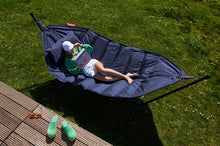 Load image into Gallery viewer, Model Laying on a Dark Blue Fatboy Headdemock Deluxe Hammock Reading a Book