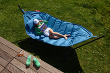 Load image into Gallery viewer, Model Laying on a Jeans Light Blue Fatboy Headdemock Deluxe Hammock Reading a Book
