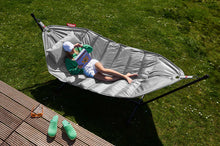 Load image into Gallery viewer, Model Laying on a Light Grey Fatboy Headdemock Deluxe Hammock Reading a Book