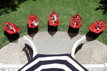 Load image into Gallery viewer, Models Laying on Red Fatboy Headdemock Hammocks on the Lawn
