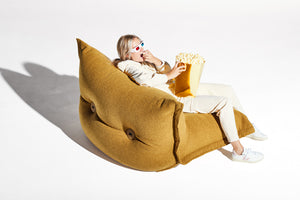 Model Sitting on a Cider Fatboy BonBaron Sherpa Eating Popcorn