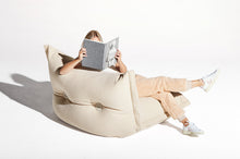 Load image into Gallery viewer, Model Sitting on an Ecru Fatboy BonBaron Sherpa Reading a Book
