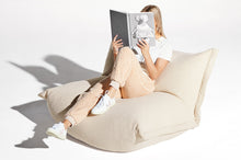 Load image into Gallery viewer, Model Sitting on an Ecru Fatboy BonBaron Sherpa Reading a Book