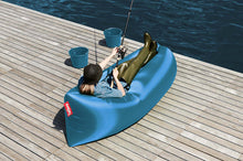 Load image into Gallery viewer, Girl Laying  on a Sky Blue Fatboy Lamzac by the Water