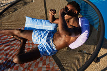 Load image into Gallery viewer, Guy Laying on a Fatboy Netorious Lounger by the Pool