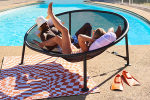 Guy and Girl Laying on a Fatboy Netorious Lounger by the Pool