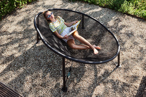 Girl Laying on a Fatboy Netorious Lounger Reading a Book