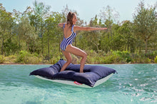 Load image into Gallery viewer, Model Standing on a Dark Ocean Fatboy Floatzac in a Pool
