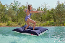 Load image into Gallery viewer, Model Standing on a Dark Ocean Fatboy Floatzac in a Pool