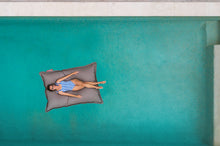 Load image into Gallery viewer, Model Floating on a Grey Taupe Fatboy Floatzac in the Pool