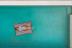Model Floating on a Grey Taupe Fatboy Floatzac in the Pool