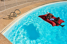 Load image into Gallery viewer, Model Floating on a Red Fatboy Floatzac in a Pool