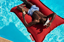Load image into Gallery viewer, Model Floating on a Red Fatboy Floatzac in a Pool