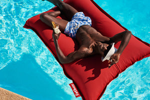 Model Floating on a Red Fatboy Floatzac in a Pool