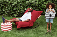 Load image into Gallery viewer, Guy Sitting on a Red Fatboy Original Outdoor Bean Bag with a Rock 'n Roll Rocker