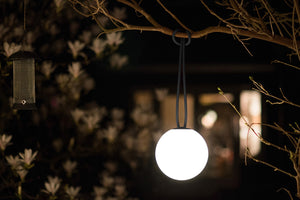 Anthracite Fatboy Bolleke Lamp Hanging on a Tree Branch at Night