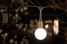 Load image into Gallery viewer, Light Grey Fatboy Bolleke Lamp Hanging on a Tree Branch at Night