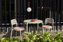 Load image into Gallery viewer, Red Fatboy Bolleke Lamp Hanging on a Fence Post