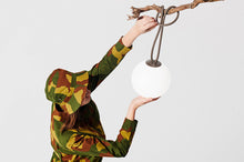 Load image into Gallery viewer, Model Hanging a Taupe Fatboy Bolleke Lamp from a Tree Branch