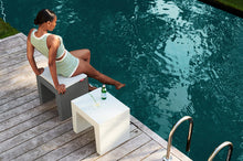 Load image into Gallery viewer, Lady Sitting on a Grey Fatboy Concrete Seat by the Water