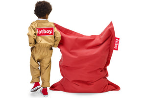 Boy Standing Next to a Red Fatboy Junior Stonewashed Bean Bag Chair