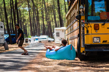 Load image into Gallery viewer, Guy Laying in a Fatboy Lamzac the Original by a Bus
