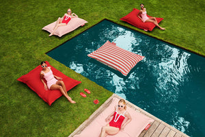 Girls Sitting on Fatboy Original Outdoor Bean Bags by a Pool