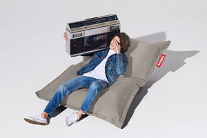 Guy Sitting on a Grey Taupe Fatboy Original Outdoor Bean Bag