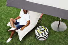 Load image into Gallery viewer, Guy Sitting on a Mist Fatboy Original Outdoor Bean Bag with a Rock 'n Roll Rocker