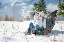 Load image into Gallery viewer, Girl Sitting on a Rock Grey Fatboy Original Outdoor Bean Bag in the Snow