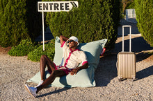 Load image into Gallery viewer, Guy Laying on a Seafoam Fatboy Original Outdoor Bean Bag