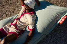 Load image into Gallery viewer, Guy Laying on a Seafoam Fatboy Original Outdoor Bean Bag