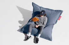 Load image into Gallery viewer, Guy Sitting on a Blue Fatboy Original Stonewashed Bean Bag