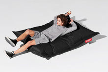 Load image into Gallery viewer, Guy Laying on a Black Fatboy Original Slim Nylon Bean Bag
