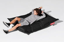 Load image into Gallery viewer, Guy Laying on a Black Fatboy Original Slim Bean Bag Chair