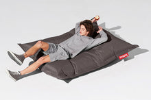 Load image into Gallery viewer, Guy Laying on a Dark Grey Fatboy Original Slim Bean Bag Chair