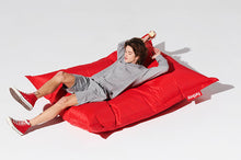Load image into Gallery viewer, Guy Laying on a Red Fatboy Original Slim Nylon Bean Bag
