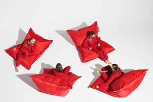 Girl Sitting on a Red Fatboy Original Slim Nylon Bean Bag in Different Positions