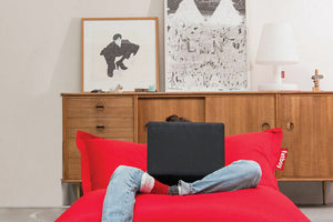 Guy With a Laptop Sitting on a Red Fatboy Original Bean Bag