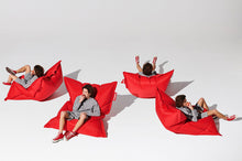 Load image into Gallery viewer, Guy Sitting on a Red Fatboy Original Slim Bean Bag Chair in Different Positions
