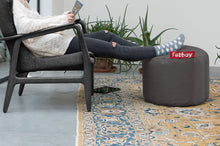 Load image into Gallery viewer, Model Sitting in Chair with Feet Up on Dark Grey Fatboy Point Ottoman