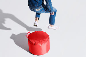 Model With a Red Fatboy Point Ottoman