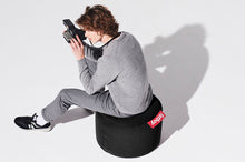 Load image into Gallery viewer, Guy Sitting on a Black Fatboy Point Stonewashed Pouf