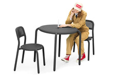 Load image into Gallery viewer, Model Sitting at an Anthracite Fatboy Toni Bistreau with Toni Chairs
