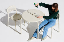 Load image into Gallery viewer, Model Sitting on a Fatboy Toni Chair at a Toni Bistreau Table
