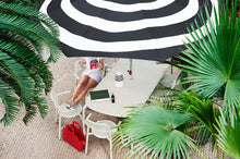 Load image into Gallery viewer, Model Sitting at a Desert Fatboy Toni Tablo with Toni Armchairs