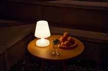 Load image into Gallery viewer, Fatboy Edison the Petit Lamp on a Bakkes Table at Night

