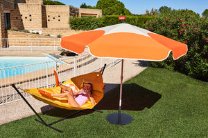 Girl Laying on a Daisy Yellow Fatboy Headdemock Deluxe Under an Umbrella