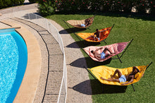 Load image into Gallery viewer, People Laying on Fatboy Headdemock Deluxe Hammocks by a Pool
